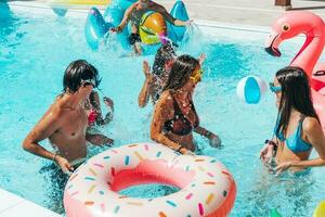 Group of friend play together in the swimming pool photo