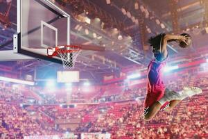 Basketball player jumping to make a basket during a match photo