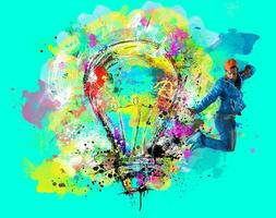 Man draws with spray a big stylized light bulb on cyan background. Concept of innovation and creativity photo