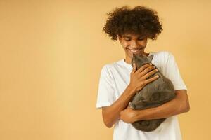 Happy man takes care of his grey cat photo