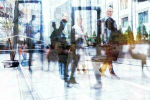 Double exposure of business men and women with light effect photo