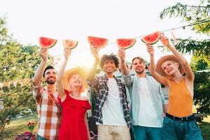Group of friends eat fresh watermelon together photo