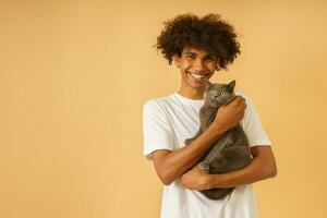 Happy man takes care of his grey cat photo