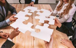 Teamwork of partners connect puzzle pieces as integration and startup photo