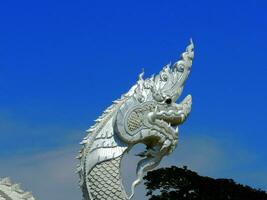 A large white Naga statue or King of Nagas at Kaeng Kabao, Mukdahan photo