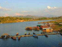 Uttamanusorn Bridge, Mon Bridge, wooden bridge across Songkalia river to the Mon Village, Sangkhlaburi, Kanchanaburi, Thailand photo