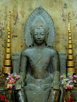 Seated Buddha statue with dangling feet or hanging feet Buddha, Wat Na Phra Men, Ayutthaya, Thailand photo