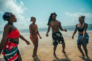 Kenyan people dance on the beach with typical local clothes photo
