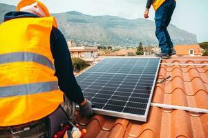 Workers assemble energy system with solar panel for electricity and hot water photo