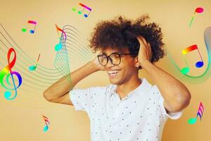 Happy afro man dances and listens to music photo