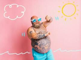 Fat man with beard, tattoos and sunglasses dances music photo