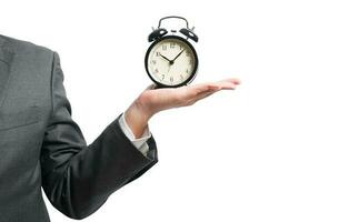 businessman hold a alarmclock to set the deadline photo