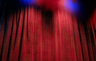 Elegant theater stage with closed red curtain photo