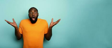 Amazed and shocked expression of a boy over cyan background photo