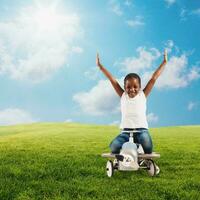 Young girl plays with an airplane toy in a green field photo