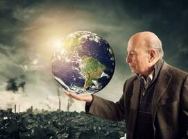 Old man saves the world from pollution. Earth provided by Nasa photo