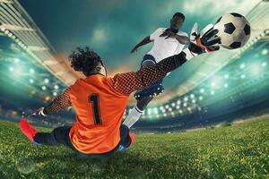 Goalkeeper catches the ball in the stadium during a football game photo