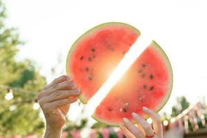 Group of friends eat fresh watermelon together photo