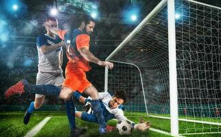 Football action with the attacker contrasted by the defenders trying to do goal at the goalkeeper photo