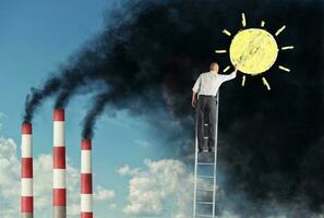 Businessman on a staircase want to change the pollution drawing the sun over the smog photo