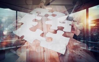 Teamwork of partners connect puzzle pieces as integration and startup. photo