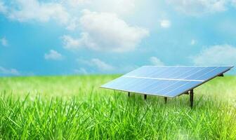 Renewable energy system with solar panel on a green field photo