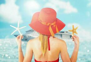 woman in swimsuit and starfish in hand enjoys the summer photo