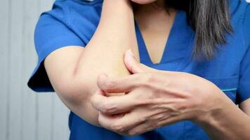 Woman scratching arm from itching video