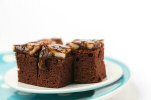 Delicious toffee cake on white background photo