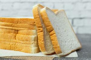 Sliced bread on dark grunge background photo