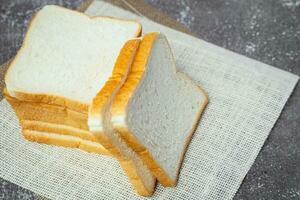 Sliced bread on dark grunge background photo