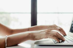 Hand using computer at home for working, e-learning and social network photo