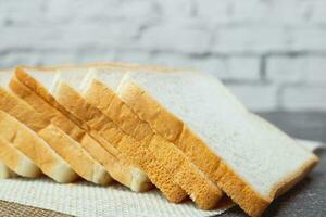 Sliced bread on dark grunge background photo