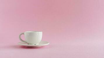 White coffee cup on pink background photo