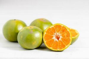 Orange on white wooden background photo