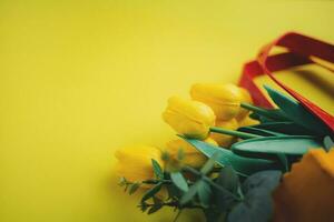 Selective focus of yellow tulips in shopping bag photo