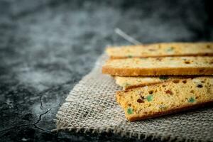 Homemade delicious biscotti on dark background photo