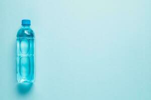 Drinking water bottle on blue background photo