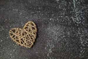 Wooden wicker heart on grunge background photo