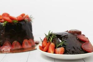 A piece of delicious chocolate cake with strawberries photo