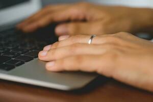 Close up of hand using the computer laptop photo