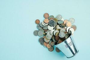 Full of money coins in a tin bucket photo