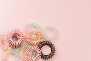 Spiral hair rubber bands on pink background photo