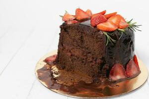 The portion of delicious chocolate cake with strawberries photo
