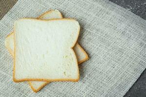 Sliced bread on dark grunge background photo