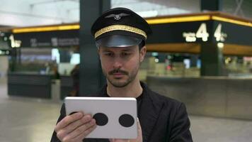 Airline pilot captain working at airport terminal in a uniform video