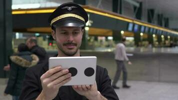 Airline pilot captain working at airport terminal in a uniform video