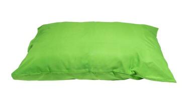 Green pillow after guest's use at hotel or resort room is isolated on white background with clipping path. Concept of confortable and happy sleep in daily life photo