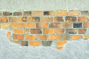 Old dirty grey concrete background texture with orange bricks in the middle used in decorative art work. Gray concrete wall texture or brick wall with strange pattern and stripes photo