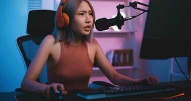 Asian young Esport woman gamer play online game on PC feel upset photo